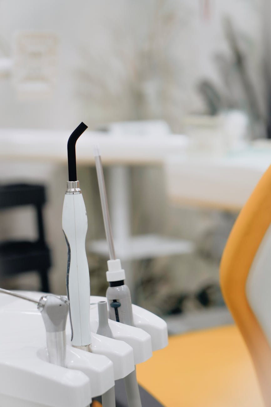 a white and black saliva ejector on holder